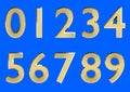 Set of 3D rendered numbers, 0-9. Golden glossy color on blue background for easy use. Royalty Free Stock Photo