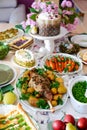 A set and decorated Easter table with festive appetizers, pastries, a baked leg of lamb and painted eggs Royalty Free Stock Photo