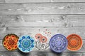Set of decorative ceramic plates hand painted dot pattern with acrylic paints on a gray wooden background. Copy space Royalty Free Stock Photo