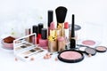 Set of decorative cosmetic: powder, lipsticks, brush, blush, eyeshadow, nail polish on a white background