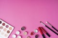 Set of decorative cosmetics with brushes over pink background Royalty Free Stock Photo