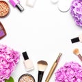 Set of decorative cosmetics mascara powder lipstick eyeshadow blush makeup brush pink hydrangea flowers on light background top Royalty Free Stock Photo