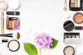 Set of decorative cosmetics mascara powder lipstick eyeshadow blush makeup brush pink hydrangea flowers star confetti on light Royalty Free Stock Photo