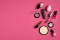 Set of decorative cosmetics on pink background. Flat lay, top view, copy space. Beauty and fashion concept