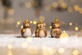 Set of decorative figurines toy owl with a golden crown on his head. Festive decor, warm bokeh lights Royalty Free Stock Photo