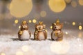 Set of decorative figurines toy owl with a golden crown on his head. Festive decor, warm bokeh lights Royalty Free Stock Photo