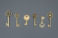 Set of decorative gilded and aged keys made of copper or bronze, close-up, top view, flat lay, isolated on black background