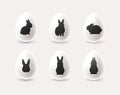 Set of decorative minimalistic white Easter eggs with black rabbit silhouettes. - Vector Royalty Free Stock Photo