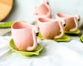 Set of decorative mugs and saucers on a white background