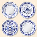 Set of decorative porcelain plates with blue national pattern in Gzhel style.