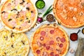 Set of delicious pizzas with bacon, cheese and mushrooms on white wooden background. Royalty Free Stock Photo