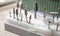 Set of dental rotary tools and metal burs used in lab for preparation and processing of metal-ceramic crowns Royalty Free Stock Photo