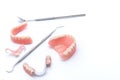 Set of dentures and dental tools on white background Royalty Free Stock Photo