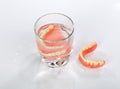 A set of dentures in a glass of water Royalty Free Stock Photo