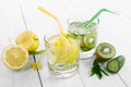Set of diet drinks, mineral water in a glass, fresh green kiwi, mint and cucumber, lemon and yellow apple. Detoxification and Royalty Free Stock Photo