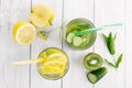 Set of diet drinks, mineral water in a glass, fresh green kiwi, mint and cucumber, lemon and yellow apple. Detoxification and Royalty Free Stock Photo