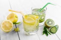 Set of diet drinks, mineral water in a glass, fresh green kiwi, mint and cucumber, lemon and yellow apple. Detoxification and Royalty Free Stock Photo