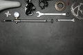 Set of different bicycle tools and parts on stone table, flat lay. Space for text