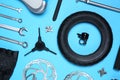 Set of different bicycle tools and parts on blue background, flat lay Royalty Free Stock Photo