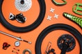 Set of different bicycle tools and parts on orange background, flat lay Royalty Free Stock Photo