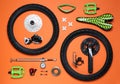 Set of different bicycle tools and parts on orange background, flat lay