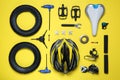 Set of different bicycle tools and parts on yellow background, flat lay Royalty Free Stock Photo