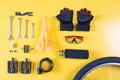 Set of different bicycle tools and parts on yellow background, flat lay. Royalty Free Stock Photo