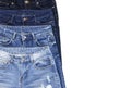 Set of different blue jeans isolated on white background top view flat lay. Detail of nice blue jeans. Jeans texture or denim