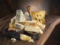 Set of different cheeses on old wooden background