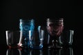 Set of colorful empty glasses on black background Royalty Free Stock Photo