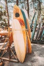 Set of different colorful surf boards in a stack