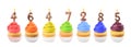 Set of different delicious birthday cupcakes with burning candles on white background