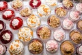 Set of different desserts on the table, top view.