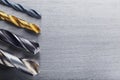 Set of different drill bits on steel plate background Royalty Free Stock Photo
