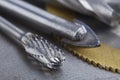 Set of different drill bits,thread tap and mill cutters with caliper ruler on steel plate background. Locksmithing deal Royalty Free Stock Photo