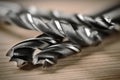 Set of different drill bits on wooden background Royalty Free Stock Photo