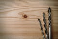 Set of different drill bits on wooden background Royalty Free Stock Photo