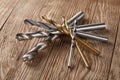 Set of different drill bits on wooden background Royalty Free Stock Photo