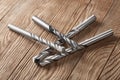 Set of different drill bits on wooden background Royalty Free Stock Photo