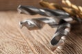 Set of different drill bits on wooden background Royalty Free Stock Photo