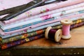 Set of different fabrics, wooden thread spools and tailor scissors Royalty Free Stock Photo