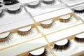 Set with different false eyelashes in packs as background Royalty Free Stock Photo