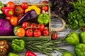 Set of different fresh raw colored vegetables in the wooden tray, light wooden background Royalty Free Stock Photo