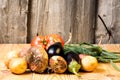 Set of different fresh raw colorful vegetables near the wooden tray, light background Royalty Free Stock Photo