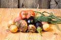 Set of different fresh raw colorful vegetables near the wooden tray, light background Royalty Free Stock Photo