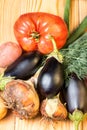 Set of different fresh raw colorful vegetables near the wooden tray, light background Royalty Free Stock Photo