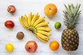 Set of different fresh tropical fruits over white wooden background Royalty Free Stock Photo