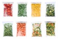 Set of different frozen vegetables in plastic bags on white background