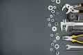 Set of different hand work tools with chrome nuts on gray backgr Royalty Free Stock Photo