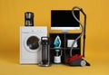 Set of different home appliances with vacuum cleaner on background